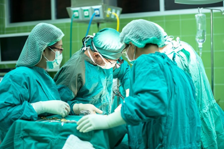 Doctors in surgery around patient